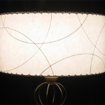 white drum lampahade wth arc pattern, by Meteor LIghts