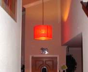 pendant drum lamp hanging in a foyer