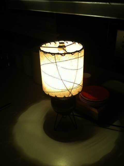 small drum lampshade, lit ,with arc pattern